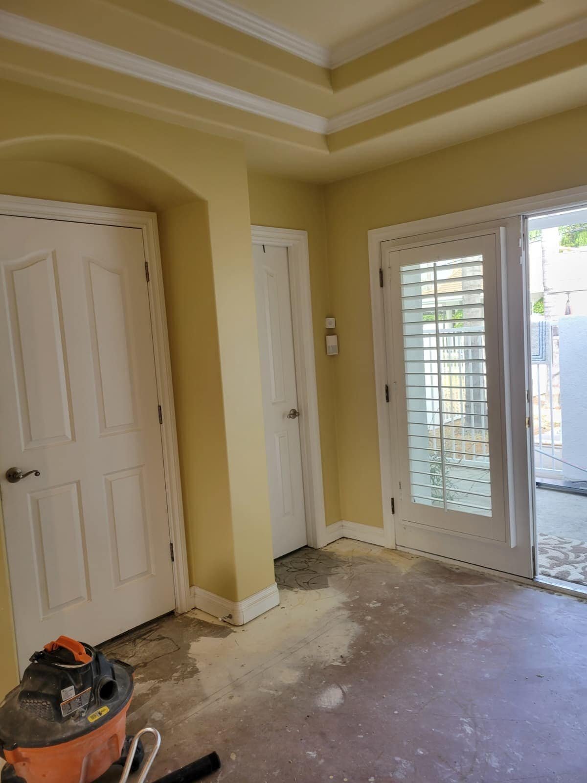 - Ceiling and wall corner detailing with crown molding in an interior home improvement scene.