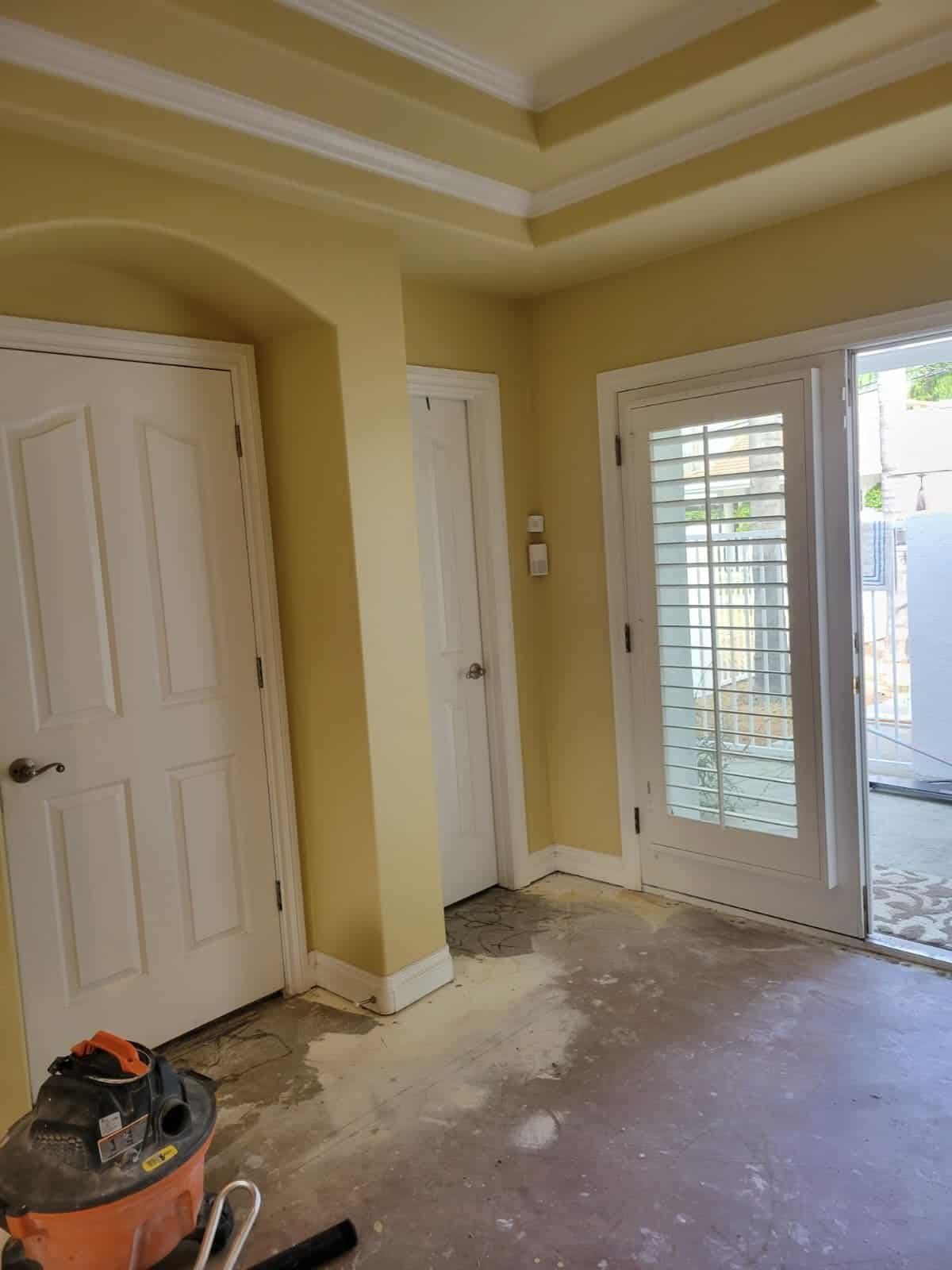 Newly renovated interior space with unfinished flooring and fresh paint, ready for home improvement or cleaning services focusing on general maintenance.