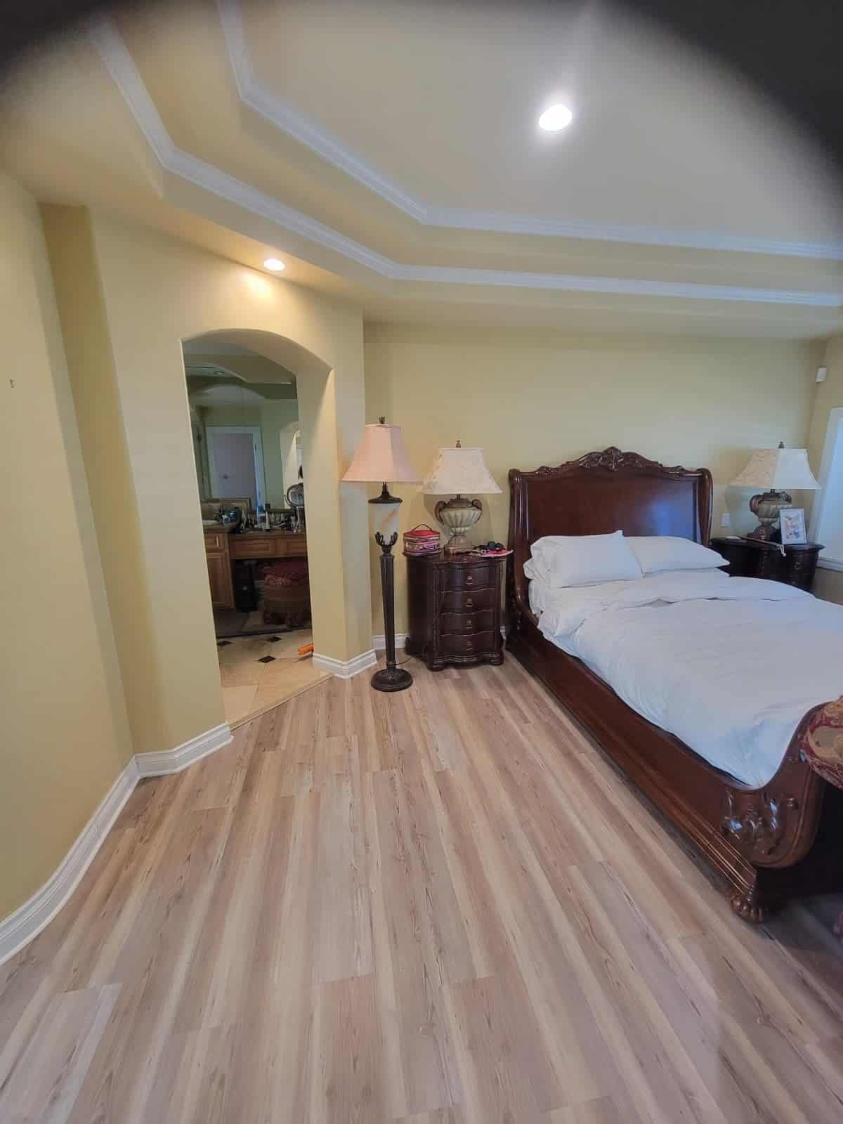 Screenshot of a bedroom with polished wooden floors, elegant wooden bed frame, matching nightstands, and lamps, showcasing general interior maintenance and home upkeep.