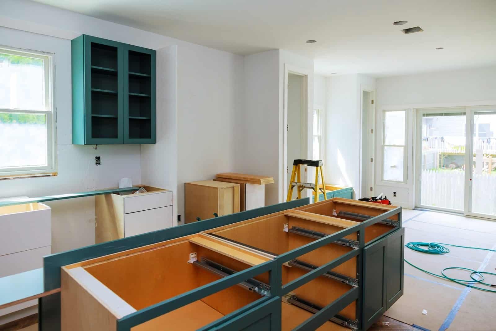 New kitchen cabinets being installed in a bright, modern home.